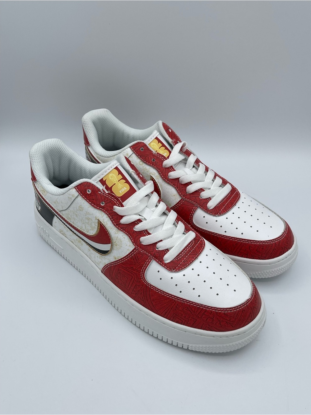 Nike Men’s White & Red Low-Top Sneakers with Gold Accents